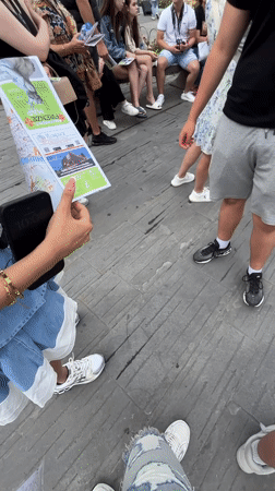 Tourist group explores Florence landmarks with maps and audio guides