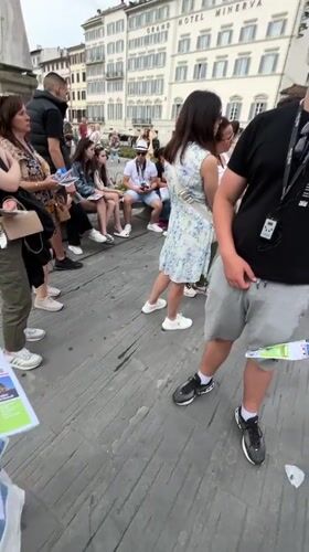 Tourist group explores Florence landmarks with maps and audio guides