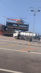 Helicopter lands on container structure in Venezuelan coastal city
