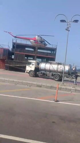 Helicopter lands on container structure in Venezuelan coastal city