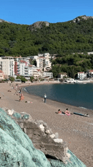 Coastal town residents enjoy sunny afternoon beach activities