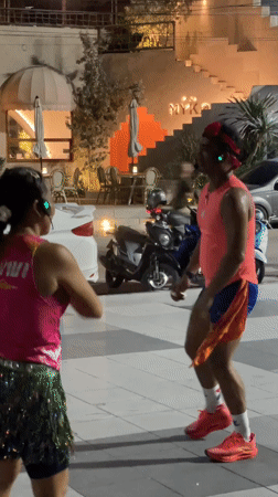 Outdoor group dance workout in a Pattaya public square at night