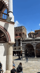 Tourist documents ornate Rila Monastery architecture and religious artwork