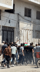 Gaza residents carry flag-draped body in street procession