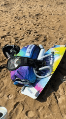 Red Bull and kitesurf gear on a Bali beach