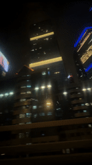 Moscow skyscrapers filmed at night from moving vehicle
