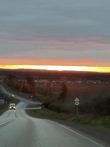 Dramatic sunset captured on rural road near Garevaya, Russia