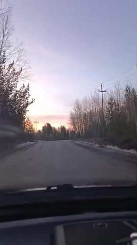 Sunset drive recorded on snowy rural road in Nizhnevartovsk