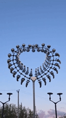 Evening documentation captures kinetic sculpture, moon, streets in Chaikovsky