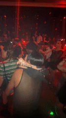Party scene captured in red-lit venue in Shanghai's Jing'an District