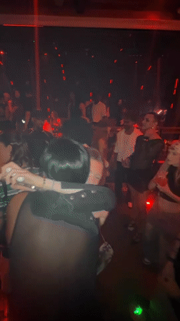Party scene captured in red-lit venue in Shanghai's Jing'an District