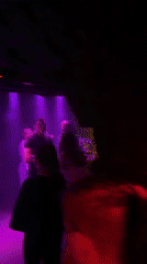 Nightclub scene captured with dancing, colored lights, fog effects