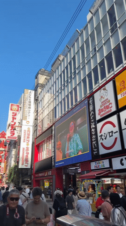 Morning street food vendors serve crowds in Osaka's Dotonbori