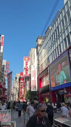 Morning street food vendors serve crowds in Osaka's Dotonbori