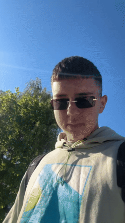 Student plays with orange balloon during casual day in Zlatograd