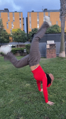 Person performs handstand on lawn in l'Hospitalet de Llobregat