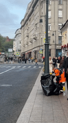Street sweeper collects trash on Moscow sidewalk