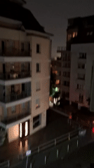 Witness documents nighttime thunderstorm over city apartment buildings