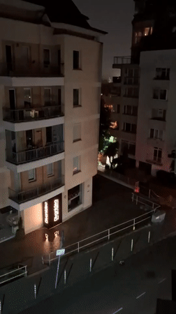 Witness documents nighttime thunderstorm over city apartment buildings