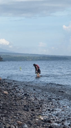 Woman applies lip gloss in Indonesia early morning