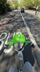 Person rides Lime scooter in London bike lane