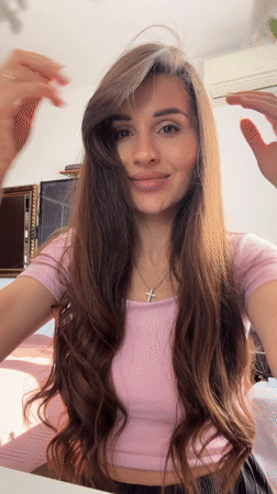 Woman captured smiling indoors in Budva, Montenegro