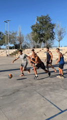 Pickup basketball on a graffiti-ringed outdoor court in Tarragona