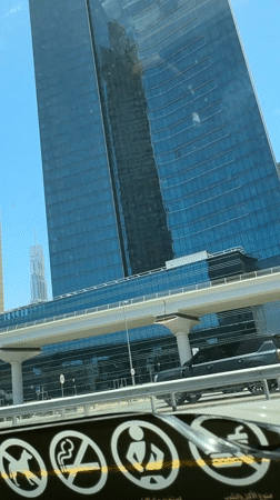 Dubai skyline photographed from vehicle on sunny morning