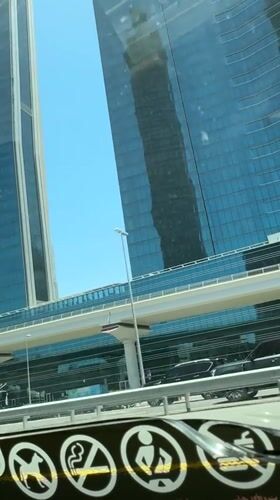 Dubai skyline photographed from vehicle on sunny morning