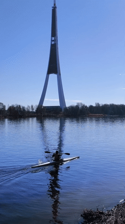 Morning kayakers paddle calm waters near Riga, Latvia