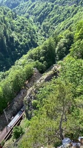 Swiss valley train and riverside stone building documented