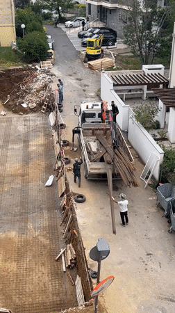 Construction crew unloads rebar at Montenegro building site