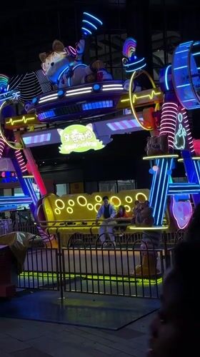 Father and child enjoy indoor amusement ride in Jiangning District