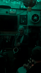 Live jazz performance draws patrons to green-lit London bar