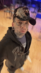 Tattooed individual films selfie near empty Buenos Aires performance hall