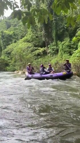 Whitewater rafting through jungle river in southern Thailand
