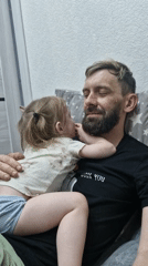 Father and daughter share quiet moment in Марковский