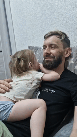 Father and daughter share quiet moment in Марковский