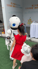 Busy Haidian plaza with a robot, teacup sculpture, and families
