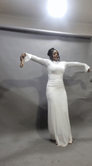 Woman dances with gold object in Onitsha photo studio