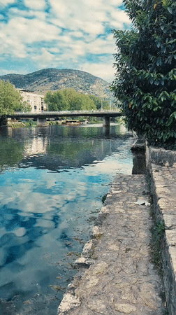 Kayaker and wildlife observed on calm Trebinje river afternoon