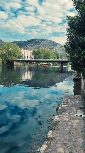 Kayaker and wildlife observed on calm Trebinje river afternoon