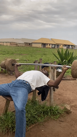 Men use makeshift equipment for outdoor workout in Nigeria