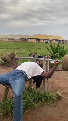 Men use makeshift equipment for outdoor workout in Nigeria