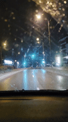 Nighttime road footage tracking multiple vehicles on wet streets