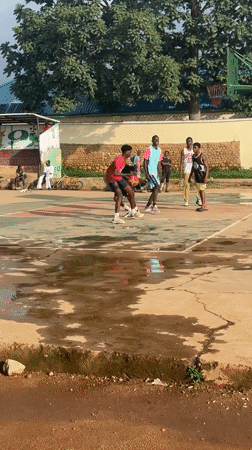 Pickup basketball on a rain-soaked court in Jos, Nigeria
