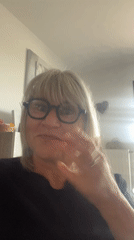 Woman waves to camera inside French residence early morning