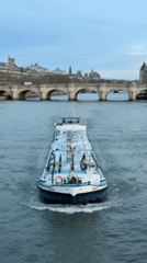 Seine River activity and Parisian landmarks observed during afternoon