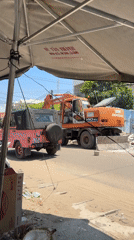 Excavator demolishes wall at construction site in Mũi Né