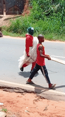Cultural procession features costumed participant on rural road
